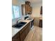 Close-up of a kitchen with dark cabinets, a white stove, and tiled backsplash at 2804 E Gowan Rd, North Las Vegas, NV 89030