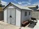 Well-maintained shed with double doors and lounge chairs provides extra storage space at 2804 E Gowan Rd, North Las Vegas, NV 89030