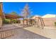 Fully fenced backyard features shade cover, mature trees and a play structure at 2809 Mountain Violet Ct, Las Vegas, NV 89108