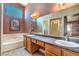 Spacious bathroom featuring double sinks, large mirror, soaking tub, and separate shower with a mauve color scheme at 2809 Mountain Violet Ct, Las Vegas, NV 89108