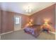 A bedroom with carpet flooring, a door to the backyard, lamps, and a ceiling light at 2809 Mountain Violet Ct, Las Vegas, NV 89108