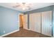 Bedroom featuring a ceiling fan, a walk-in closet, and an adjacent door leading to another room at 2809 Mountain Violet Ct, Las Vegas, NV 89108