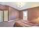 A carpeted bedroom with a door to the backyard, ceiling light, closet, and neutral-colored walls at 2809 Mountain Violet Ct, Las Vegas, NV 89108