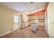 Cozy kitchen featuring tile flooring, light wood cabinets, white appliances, a kitchen island, and backyard access at 2809 Mountain Violet Ct, Las Vegas, NV 89108