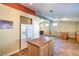 Open kitchen with tile flooring, kitchen island, white refrigerator, and bar area with views of the living space at 2809 Mountain Violet Ct, Las Vegas, NV 89108