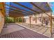Open patio features shade cover, decorative wood deck and mature landscaping at 2809 Mountain Violet Ct, Las Vegas, NV 89108