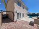 Outdoor view with a brick patio, outdoor kitchen area, swimming pool and the home's exterior at 2873 Cambretto Dr, Henderson, NV 89074
