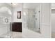 Modern bathroom features glass enclosed shower with marble surround, dark wood vanity and window with blinds at 2873 Cambretto Dr, Henderson, NV 89074