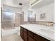 Bathroom featuring double sinks, framed mirrors, tiled shower-bathtub combo and natural light at 2873 Cambretto Dr, Henderson, NV 89074