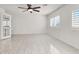 The spacious bedroom boasts tile floors, shuttered windows, and a ceiling fan, creating a bright and airy space at 2873 Cambretto Dr, Henderson, NV 89074