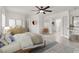Bright bedroom features a bed, ceiling fan, and a view to the bathroom at 2873 Cambretto Dr, Henderson, NV 89074