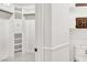 Walk-in closet with shelves and closet rod and bathroom with toilet and upper and lower cabinets at 2873 Cambretto Dr, Henderson, NV 89074