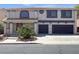 Charming two-story home featuring a two-car garage, front yard landscaping, and a welcoming covered porch at 2873 Cambretto Dr, Henderson, NV 89074