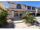 Home exterior with a landscaped front yard, covered porch, driveway, and an attached garage at 2873 Cambretto Dr, Henderson, NV 89074