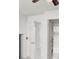 Bright hallway with white walls and tile floors and a view of a bedroom with natural light at 2873 Cambretto Dr, Henderson, NV 89074