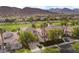 Beautiful aerial view of a home in a community with a manicured golf course and mountain views at 2933 Red Springs Dr, Las Vegas, NV 89135
