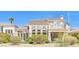 A view of a home's back exterior, complete with a second-story balcony and desert landscaping at 2933 Red Springs Dr, Las Vegas, NV 89135