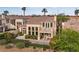 Charming backyard with manicured hedges, a patio with outdoor seating, and a built-in grill at 2933 Red Springs Dr, Las Vegas, NV 89135