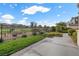 Beautiful backyard featuring well-maintained lawn, flower beds, and views of the golf course and mountains at 2933 Red Springs Dr, Las Vegas, NV 89135