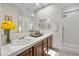Bathroom featuring a double sink vanity, framed mirrors, and a glass-enclosed shower at 2933 Red Springs Dr, Las Vegas, NV 89135