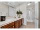 Bright bathroom with tile countertops, wood cabinets and a shower over tub at 2933 Red Springs Dr, Las Vegas, NV 89135