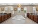 Luxurious bathroom featuring a large soaking tub, dual vanities, and abundant natural light at 2933 Red Springs Dr, Las Vegas, NV 89135