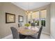 Charming dining area featuring a round marble table set, a modern chandelier, and sunny windows at 2933 Red Springs Dr, Las Vegas, NV 89135