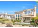 Upscale two-story home with a balcony, large windows, manicured landscaping, and a rod iron fence at 2933 Red Springs Dr, Las Vegas, NV 89135