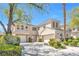 Stunning stucco home featuring a well-manicured lawn, two-car garage, and beautiful desert landscaping at 2933 Red Springs Dr, Las Vegas, NV 89135