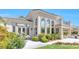 A luxurious stucco home showcasing a manicured yard, outdoor kitchen, and an abundance of windows at 2933 Red Springs Dr, Las Vegas, NV 89135