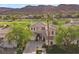 Stately two-story home with meticulously kept landscaping, circular driveway, and a palm tree in front at 2933 Red Springs Dr, Las Vegas, NV 89135