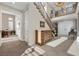Welcoming foyer featuring a staircase with dark wood railings, tile flooring, and a view of the upper level at 2933 Red Springs Dr, Las Vegas, NV 89135