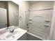 Bright bathroom featuring a clean white vanity and a tub-shower combo with built-in shelving at 2970 Saltillo Ln, Las Vegas, NV 89121