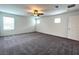 Spacious bedroom with gray carpet, ceiling fan, and natural light from multiple windows at 2970 Saltillo Ln, Las Vegas, NV 89121