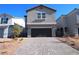 Two-story home featuring a dark garage door and paved driveway at 2970 Saltillo Ln, Las Vegas, NV 89121