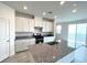Modern kitchen features granite countertops, white cabinets and stainless steel appliances at 2970 Saltillo Ln, Las Vegas, NV 89121