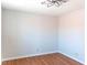 A bright bedroom with wood floors, white walls, and a modern light fixture provides a clean and spacious feel at 3008 Blue Fin Cir, Las Vegas, NV 89128