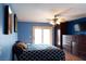 Bedroom boasts blue walls, dark wood furniture, ceiling fan, and sliding glass door to a private balcony at 3008 Blue Fin Cir, Las Vegas, NV 89128