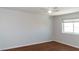 Bright bedroom with wood floors, neutral paint, ceiling fan, and a sunny window at 3008 Blue Fin Cir, Las Vegas, NV 89128