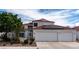 Two-story home with a white exterior, red tile roof, three-car garage, and a well-manicured front yard at 3008 Blue Fin Cir, Las Vegas, NV 89128