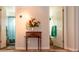 Inviting hallway with decorative table featuring a flower arrangement between two bathroom entrances at 3008 Blue Fin Cir, Las Vegas, NV 89128