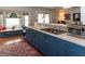 Kitchen boasts blue cabinets, granite countertops, stainless steel appliances, gas range, and bright windows at 3008 Blue Fin Cir, Las Vegas, NV 89128
