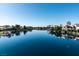 Calm lake reflecting nearby homes, trees, and blue sky at 3008 Blue Fin Cir, Las Vegas, NV 89128
