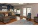 Living room features hardwood floors, access to the kitchen, and glass doors to the backyard at 3008 Blue Fin Cir, Las Vegas, NV 89128