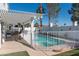 Inviting pool with covered patio, grill, and white picket fence for outdoor enjoyment at 3008 Blue Fin Cir, Las Vegas, NV 89128