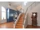Stylish staircase with wood steps and stainless steel railings adjacent to the gourmet kitchen at 3008 Blue Fin Cir, Las Vegas, NV 89128