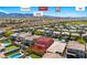 Stunning aerial view of a charming neighborhood with lush green spaces and a picturesque mountain backdrop at 3042 Echoed Rondel Ln, Henderson, NV 89044