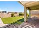 A spacious backyard features artificial turf, a brick border, and a covered patio area at 3042 Echoed Rondel Ln, Henderson, NV 89044