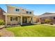 Backyard with manicured lawn, covered patio, and lush landscaping at 3042 Echoed Rondel Ln, Henderson, NV 89044