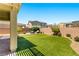 Expansive backyard featuring lush artificial turf and a cozy seating area, perfect for outdoor living at 3042 Echoed Rondel Ln, Henderson, NV 89044